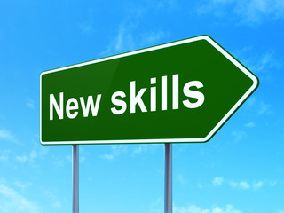 Education concept: New Skills on road sign background