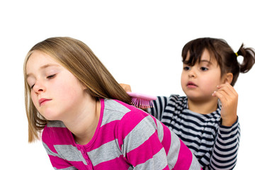 two little girls combing