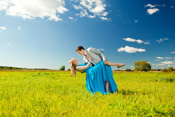 Fototapeta premium Happy young adult couple in love on the field. Two, man and wom