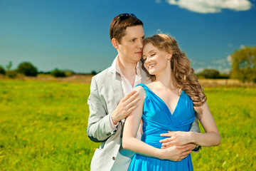 Obraz premium Happy young adult couple in love on the field. Two, man and wom