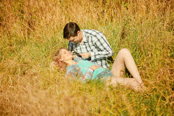 Happy young adult couple in love on the field. Two,  man and wom