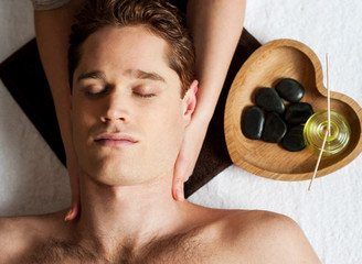 Obraz na płótnie Canvas Young man getting face massage