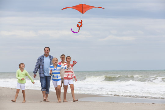 Family Parents Girl Children Flying Kite on Beach