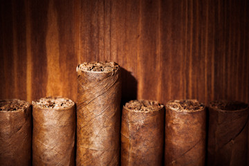 cigars on wooden background