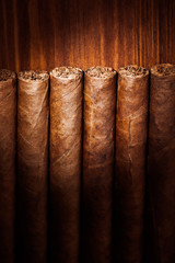 cigars on wooden background