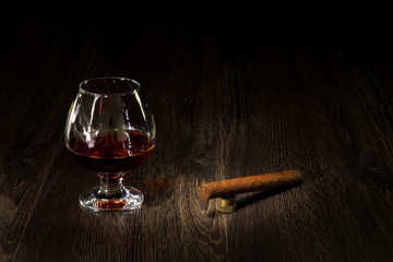 Cognac, cigar and an old book nearby