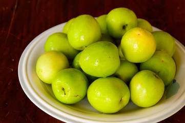 chinese jujube in white plate on wooden background