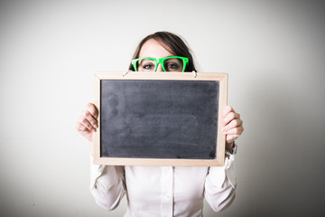 beautiful young businesswoman holding blackboar