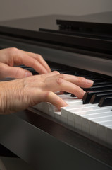 Fototapeta na wymiar Two hands playing on the piano