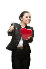 smiling young business woman holding red heart