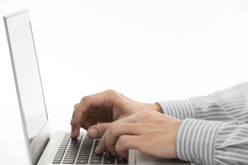 Close-up of male hands typing on laptop