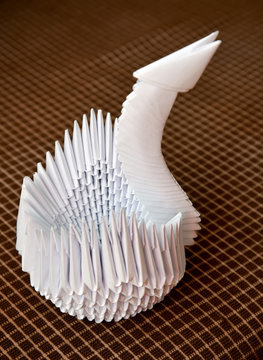 White Swan In Equipment Of Origami Against A Dark Background