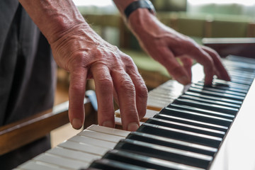 Senior man playing piano