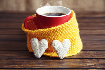 A cup of coffee in a scarf