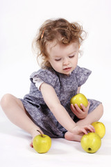 Fototapeta premium Little girl playing with apples