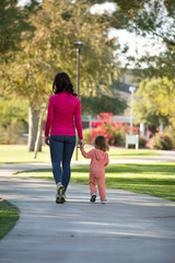 Beautiful mother and daughter walking in the neighborhood