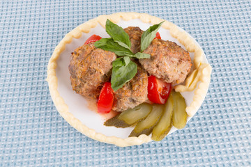 lula lamb and tomato on a plate on the table