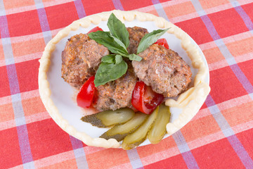 lula lamb and tomato on a plate on the table