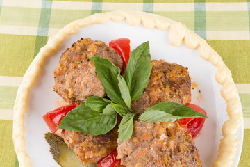 lula lamb and tomato on a plate on the table