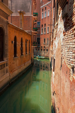 City streen in Venice with green water