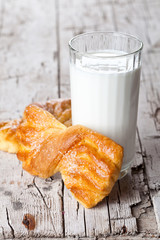 glass of milk and two fresh baked buns