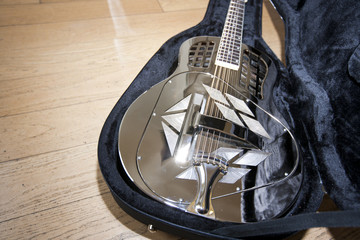 Close-up view of resonator guitar in carry case
