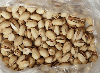 Closeup of pistachios in nut shells as food background
