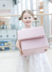 Young girl holding two gift wrapped boxes