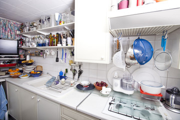 Interior of domestic kitchen with utensils and shelves