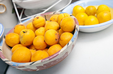 Yellow peaches in bowl at kitchen counter
