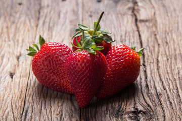 Fresh strawberries on old wooden background