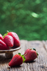 Strawberries on old wooden, With green bokeh abstract light back