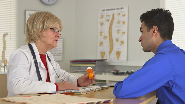 Side View Of Doctor Explaining Medication