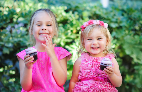 group of two cute fashion little girls eat happy birthday pink c