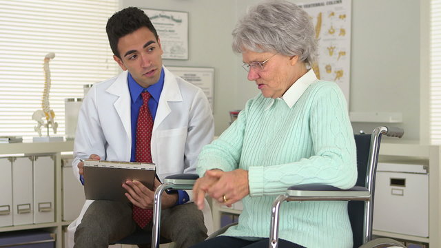 Elderly woman talking with Mexican doctor