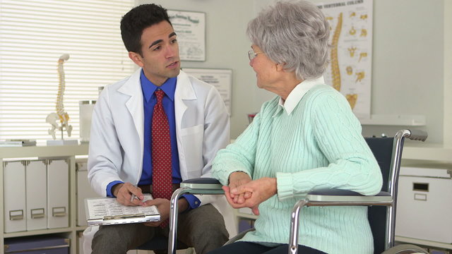 Elderly woman talking with Mexican doctor