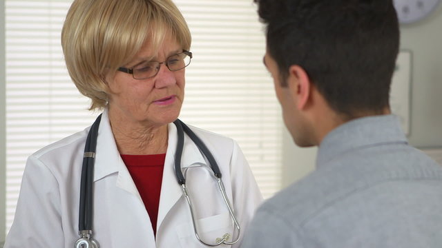 Doctor talking with Mexican patient
