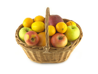 Brown wicker basket full of ripe fruits isolated closeup