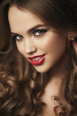Fototapeta premium Portrait of beautiful girl with red lips, red manicure. Close up
