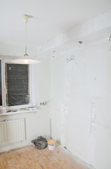 Room renovation. Gypsum plasterboard with undone socket bulbs.