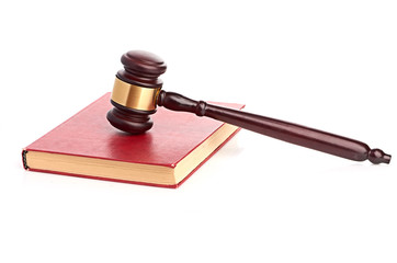 Judge's gavel on red legal book