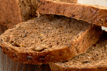Slices of brown bread on a wooden table
