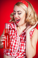 Beautiful pinup girl drinking soft drink from glass bottle