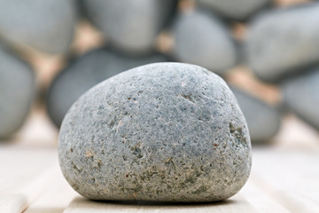 Sauna stones. Stacked on a wooden surface. Ready for heating.