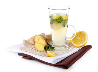 Cup of tea with ginger on napkin isolated on white