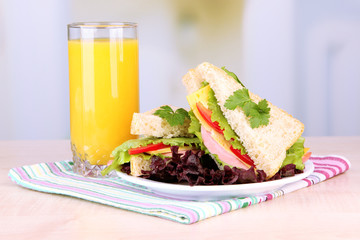 Fresh and tasty sandwiches on plate on table on light