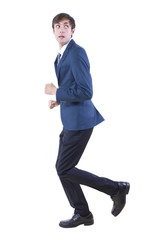 young caucasian businessman running away from imaginary threat