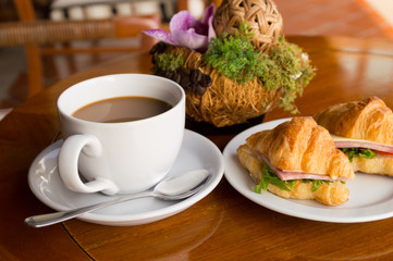 morning breakfast - coffee and croissant sandwish on restaurant