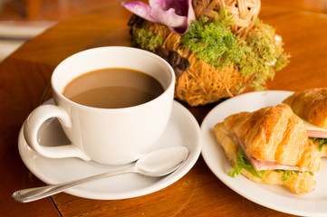 morning breakfast - coffee and croissant sandwish on restaurant