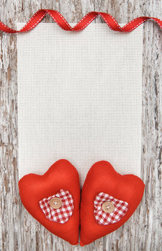 Valentine card with textile hearts on old wood